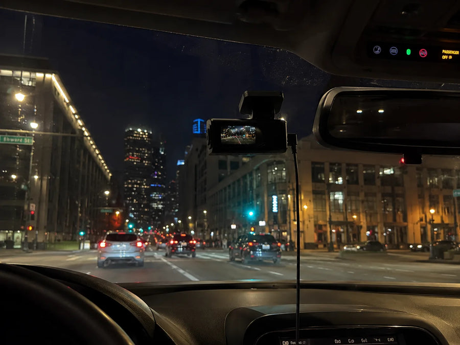 Plainview One recording a lit city street at night